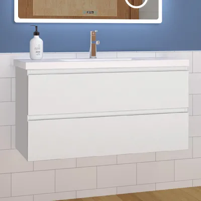 A white wall-mounted bathroom vanity with two drawers is shown against a blue tiled wall.