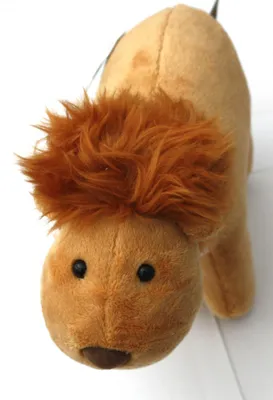 A plush toy lion is shown from a close-up, slightly angled perspective against a white background.