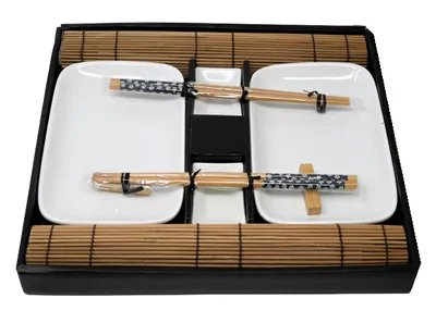 A sushi set laid out on a black tray with bamboo mats.