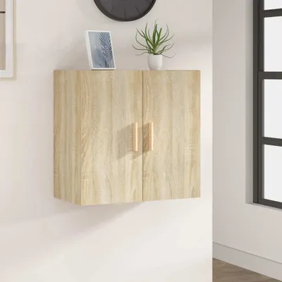 A wall-mounted cabinet with two doors is shown against a white wall. A framed picture and a potted plant are on top of the cabinet.
