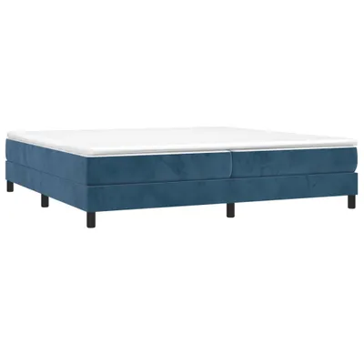 A blue boxspring bed frame with a white mattress on top, shown from a side angle against a white background.