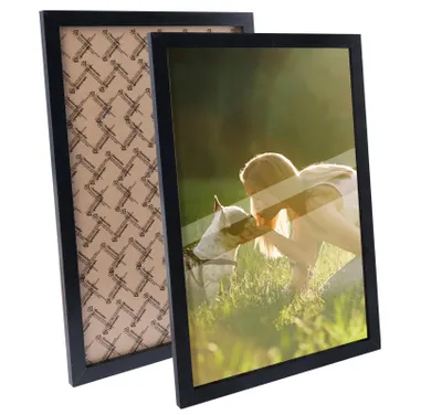 Two black picture frames are shown. One frame is in the foreground and displays a picture of a person and a dog. The other frame is behind the first and shows its backing.