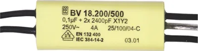 A close-up of a yellow capacitor with black and gray wires.