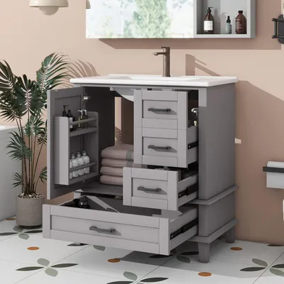 A bathroom vanity with an open door and drawers, showcasing storage and a sink.