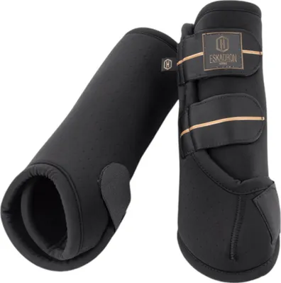 A pair of black dressage boots for horses.