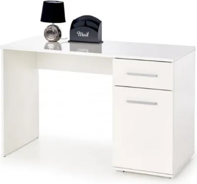 A white desk with a black lamp and a black mail holder on top.