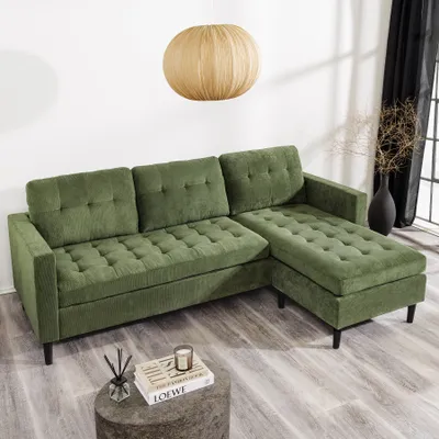 A green sectional sofa in a well-lit room.