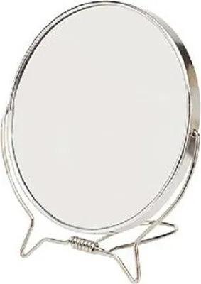 A close-up shot of a round makeup mirror on a stand.