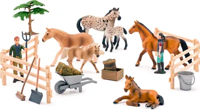A collection of toy farm animals and accessories, including horses, a farmer, fences, a wheelbarrow, and a tree, arranged on a white background.