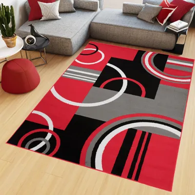 A modern living room with a sectional sofa and a geometric rug.