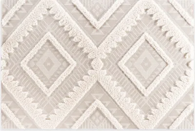 A close-up view of a beige and white patterned rug.