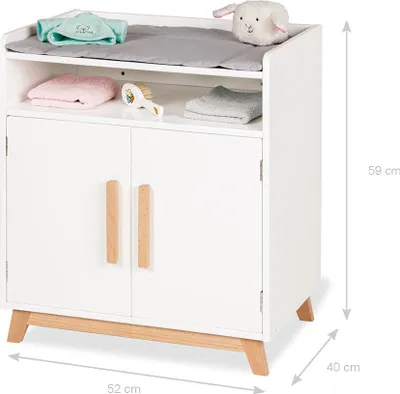 A white baby changing table with wooden accents and accessories.