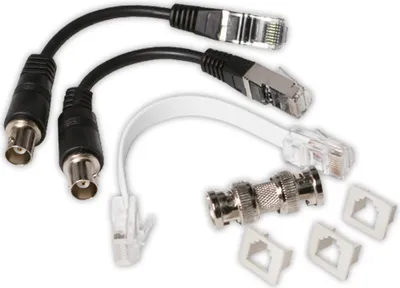 A collection of network cables and adapters, including BNC to Ethernet adapters and Ethernet cables.
