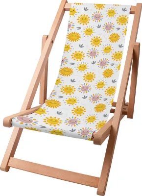 A wooden deck chair with a colorful fabric seat featuring a pattern of smiling suns and small leaves.
