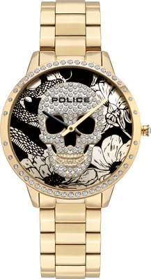 A close-up, front-facing studio shot of a gold-colored women's watch with a skull and floral design on the face.