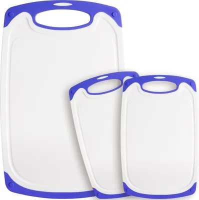 Three white cutting boards with purple trim and handles are arranged in a staggered formation against a white background.
