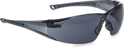 A pair of dark gray safety sunglasses with tinted lenses, shown from a side angle against a white background.