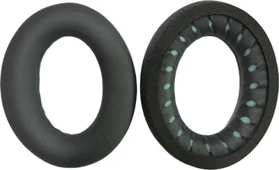 Two black ear pads for headphones are shown side-by-side against a white background. The left ear pad is a complete cushion, while the right ear pad is shown from the inside, revealing its foam padding and light blue accents.
