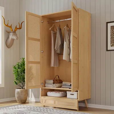 An open wooden wardrobe with clothes hanging inside and items on shelves.