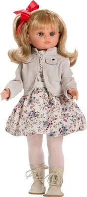 A full-body studio shot of a doll against a white background.