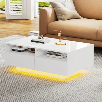 A modern white coffee table with LED lighting is placed on a gray rug in a living room setting, next to a tan sofa.