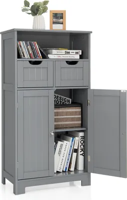 A gray bathroom cabinet with its doors open, displaying books and decorative items inside.