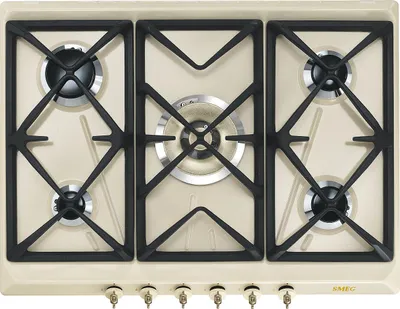 A top-down view of a cream-colored gas hob with black grates and silver burner caps.