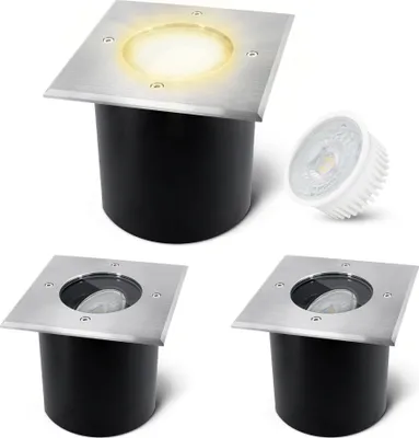 A set of three square, flat, ground-recessed LED spotlights with stainless steel tops and black cylindrical bases, and one separate LED bulb.