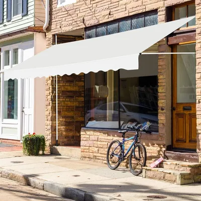 A white awning is extended over the storefront of a building. A bicycle is parked on the sidewalk in front of the building.