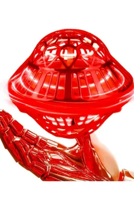 A metallic red robotic hand holds a red, translucent, UFO-shaped toy.