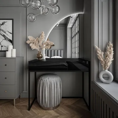 A modern vanity table with a mirror and stool in a well-decorated room.