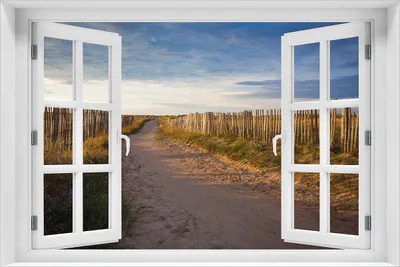 Produktbild von Wallario Wandbild aus Acryl, 60 x 90 cm, freischwebende Optik - Sandweg an einem Strand in Frankreich, Bretagne mit Fenster-Illusion