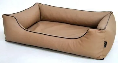 A tan dog bed with black trim is shown from a slightly elevated side angle against a white background.