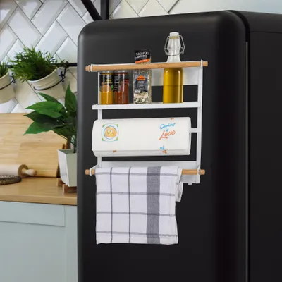 A magnetic kitchen shelf with kitchen items attached to a refrigerator.