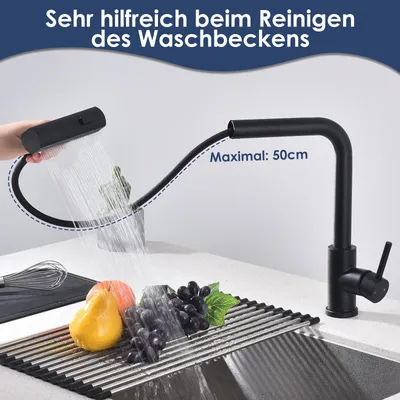 A kitchen faucet is shown with its pull-out spray head extended, demonstrating its reach over a sink with fruit and a whisk. The text indicates its usefulness for cleaning the sink and its maximum extension.