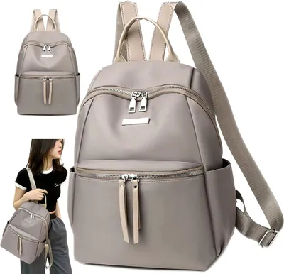 A woman is holding a gray backpack, with a larger image of the same backpack next to her.