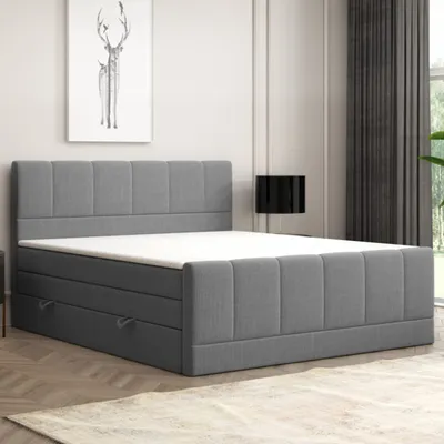 A modern upholstered bed frame with drawers in a bedroom setting.