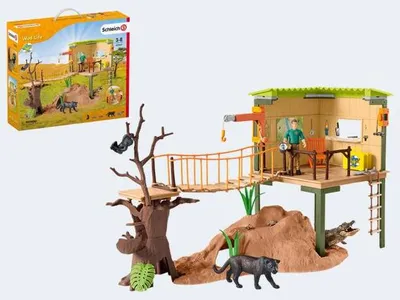 A toy playset depicting a wildlife adventure station with animals and a ranger.