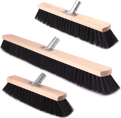 Three brooms of different sizes are arranged diagonally on a white background.