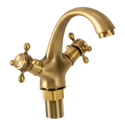 A close-up studio shot of a vintage-style brass faucet.