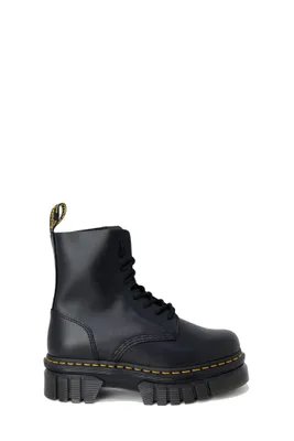 A black Dr. Martens boot on a white background.