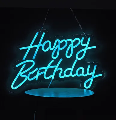 A blue neon sign that says "Happy Birthday" is hanging against a black background.