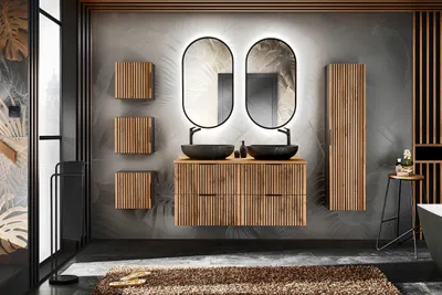 A modern bathroom with a double vanity, mirrors, and storage cabinets.