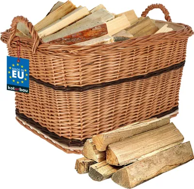 A wicker basket filled with firewood, with a few pieces of firewood stacked in front of it.