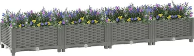 A long, rectangular planter box filled with purple and yellow flowers, set against a white background.