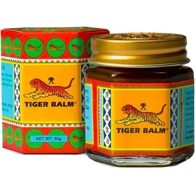 A jar of Tiger Balm and its packaging are shown against a white background.