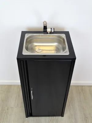 A black cabinet with a stainless steel sink and faucet on top, set against a white wall.