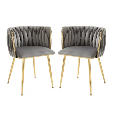 Two gray velvet chairs with gold metal frames are shown against a white background.