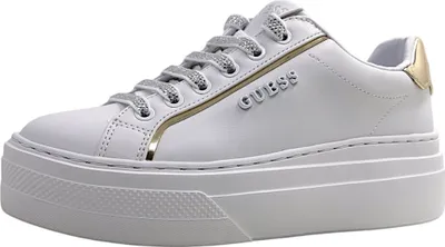 A white Guess sneaker with gold and silver accents is shown against a white background.
