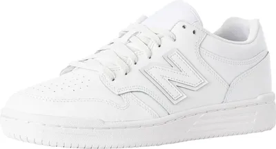 A white New Balance sneaker is shown from a side angle against a white background.